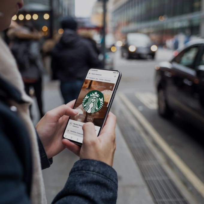 A mobile phone showing Google Display Ads of Starbucks.