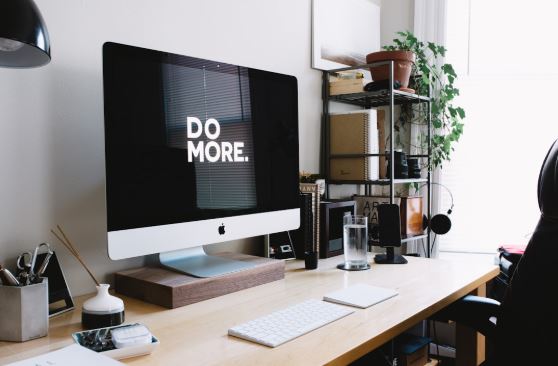 A monitor showing  "Do More" sign, promoting productivity and focus.