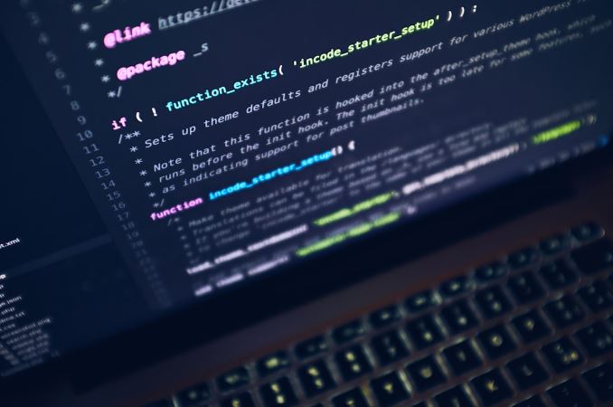 Laptop displaying programming code, symbolizing software development.