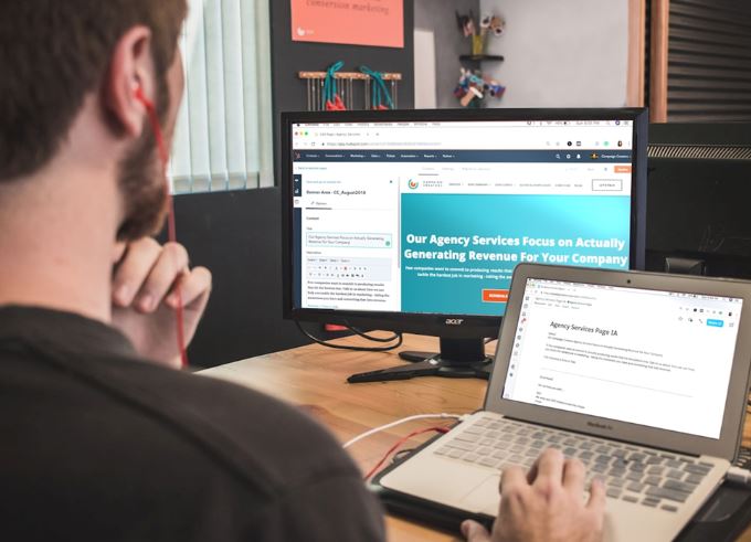 A man working on a laptop, focused on responsive web design.