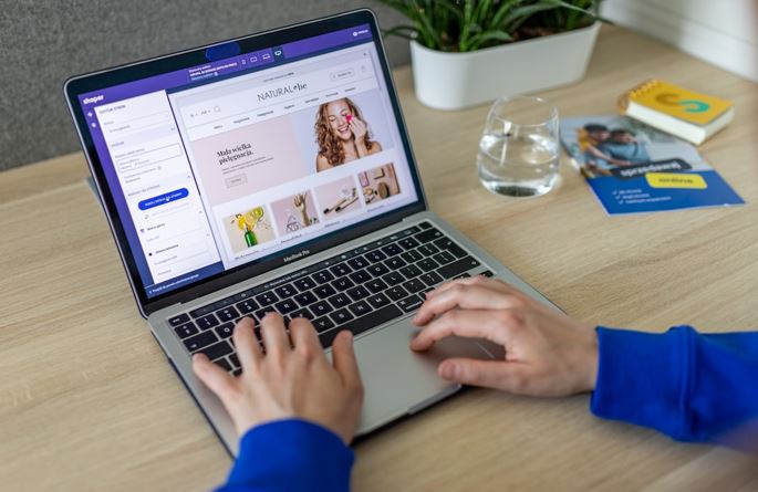 A person working on a laptop, focused on ad targeting strategies and digital marketing analysis.