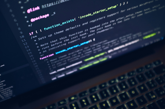 Close-up of code on screen representing AI integration and enhanced search engine result page features.