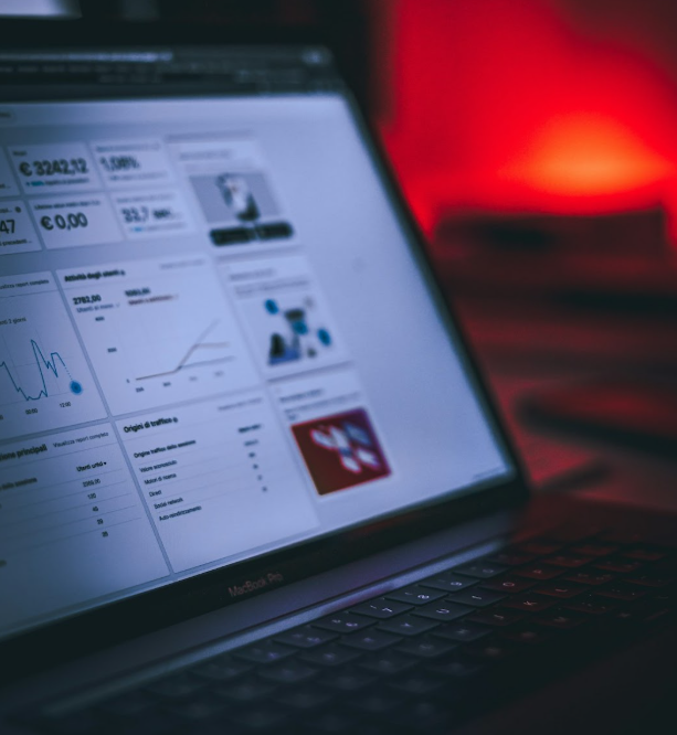 Close-up of a MacBook screen displaying data analytics dashboards with charts and performance metrics for digital marketing insights