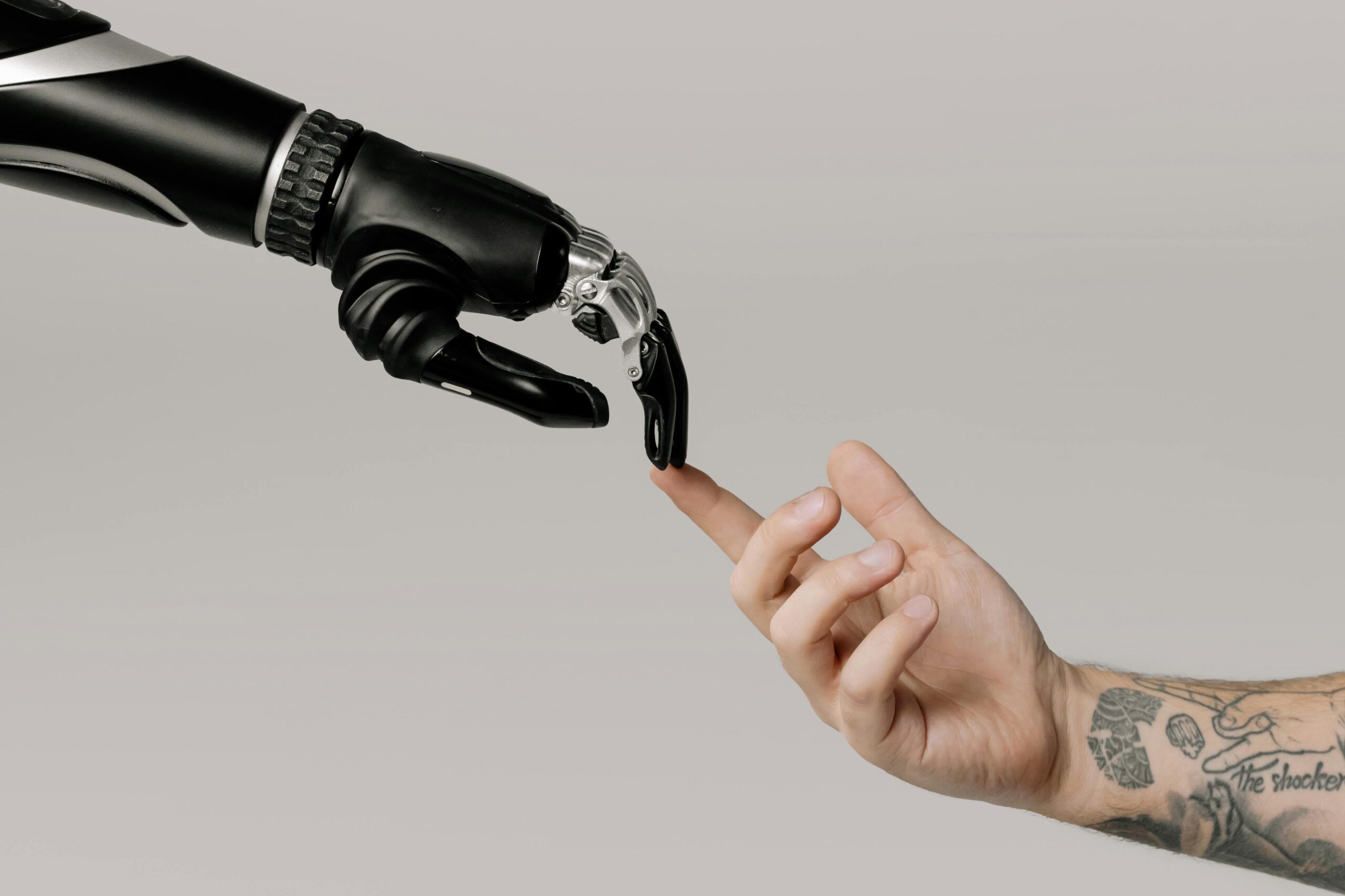 Human hand touching robotic finger, symbolizing the intersection of AI and human search behavior.