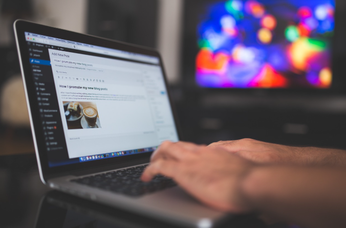 Person editing a blog post on laptop, focusing on mobile SEO and user experience optimization.