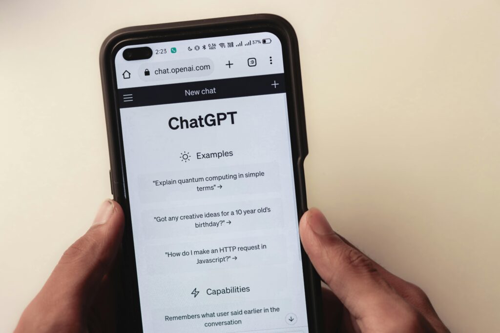 Person holding smartphone with ChatGPT interface open, highlighting AI content citation relevance.