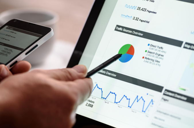 Digital marketer analyzing website traffic data on tablet to improve content credibility and authority.