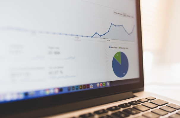 Laptop screen showing website analytics and traffic growth charts for SEO strategy