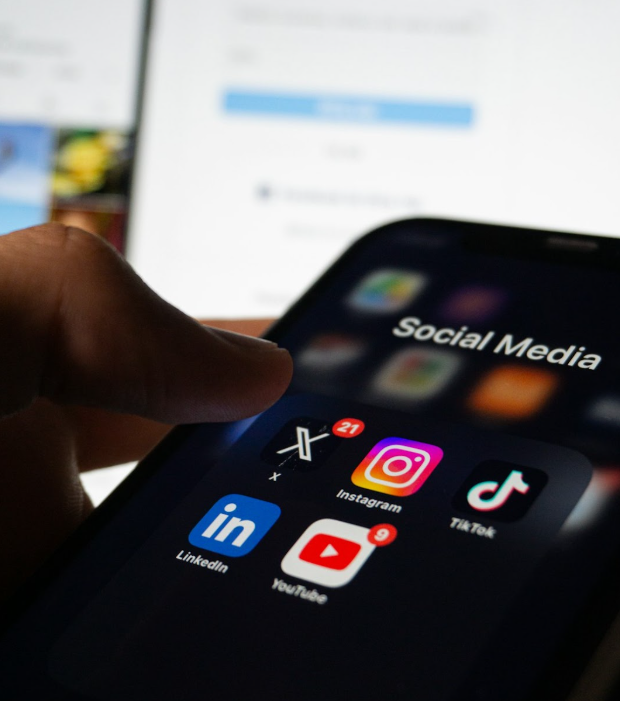 Smartphone screen showing social media apps like Instagram, LinkedIn, and TikTok for SEO marketing