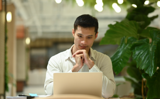 Person reviewing email layouts on a laptop, representing best practices for mobile-responsive email design that improves readability and click-through rates.