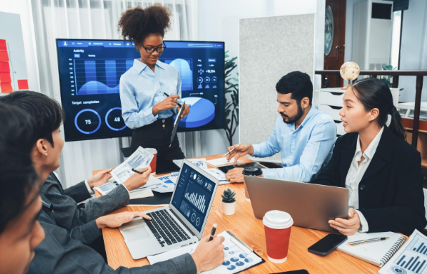 Marketing team reviewing analytics and segmentation data during a strategy meeting, illustrating techniques for creating targeted email lists and improving engagement.