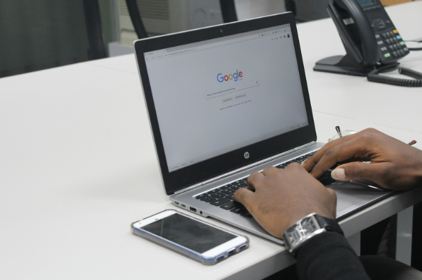 User performing a Google search on laptop illustrating changes in search results